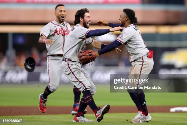 Dansby Swanson and Ozzie Albies of the Atlanta Braves celebrate the team's 7-0 victory against the Houston Astros in Game Six to win the 2021 World...
