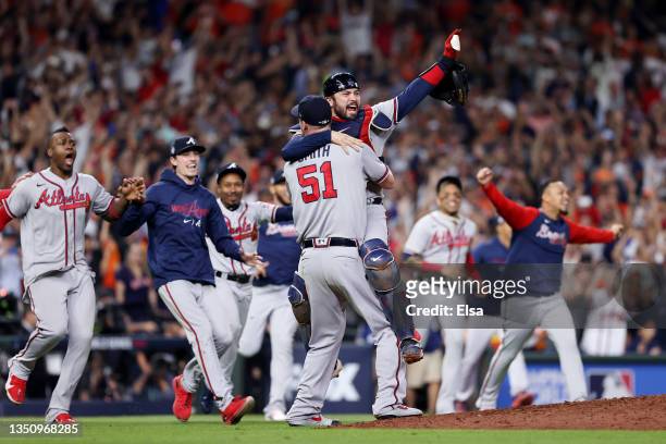 Will Smith and Travis d'Arnaud of the Atlanta Braves celebrate the team's 7-0 victory against the Houston Astros in Game Six to win the 2021 World...