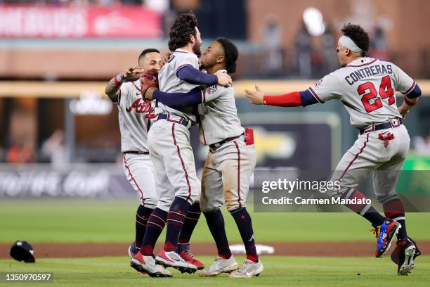Dansby Swanson of the Atlanta Braves celebrates with Ozzie Albies after their 7-0 victory against the Houston Astros in Game Six to win the 2021...
