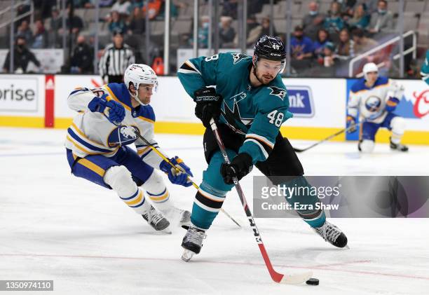 Tomas Hertl of the San Jose Sharks skates past Anders Bjork of the Buffalo Sabres on his way to scoring a goal in the second period at SAP Center on...