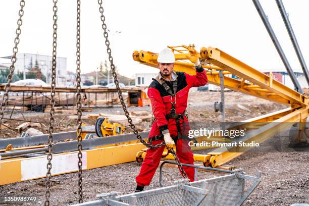 crane erection work for new construction project - hoisting stock pictures, royalty-free photos & images