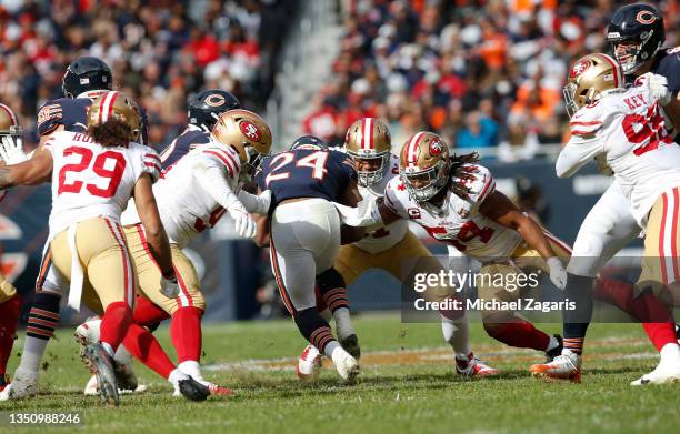 Arik Armstead, Fred Warner and D.J. Jones of the San Francisco 49ers tackle Khalil Herbert of the Chicago Bears during the game at Soldier Field on...