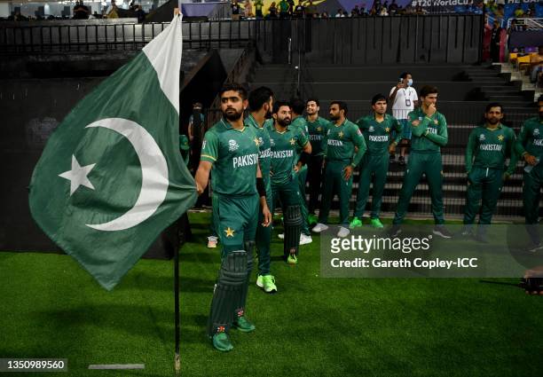 Pakistan captain Babar Azam stands with a Pakistan flag as he waits to lead on his team ahead of the ICC Men's T20 World Cup match between Pakistan...