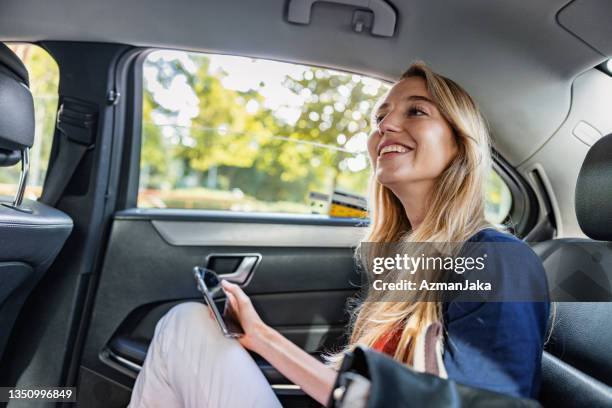 young caucasian woman walking taking a taxi in barcelona - taxi españa stockfoto's en -beelden