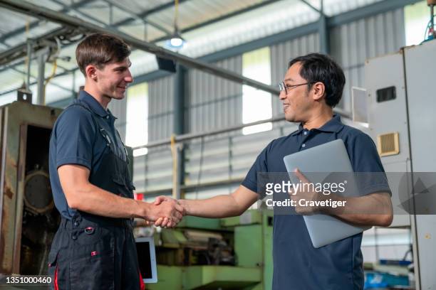 teamwork of engineers shake hands together after finish work in the industry factory. - respect trust stock pictures, royalty-free photos & images