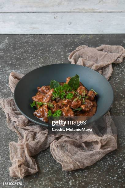 homemade goulash beef stew plate served in rustic kitchen - beef bourguignon stock pictures, royalty-free photos & images