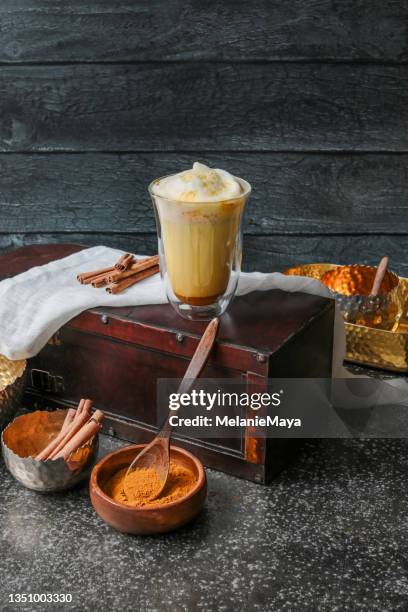 tumeric chai latte kurkuma golden milk with foam and spices - chai tea stock pictures, royalty-free photos & images