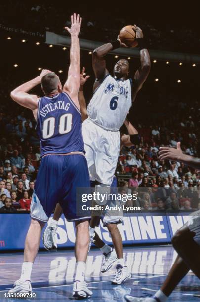 Patrick Ewing, Center for the Orlando Magic makes a jump shot as Greg Ostertag of the Utah Jazz attempts to block during their NBA Atlantic Division...