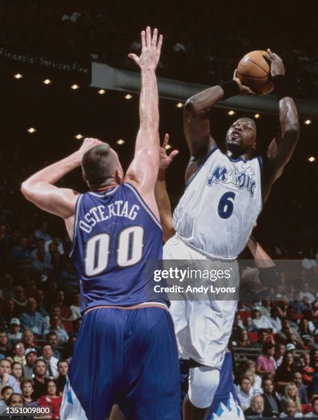 Patrick Ewing, Center for the Orlando Magic makes a jump shot as Greg Ostertag of the Utah Jazz attempts to block during their NBA Atlantic Division...