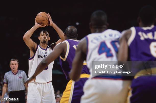 Juwan Howard, Small Forward for the Washington Wizards prepares to pass the basketball to team mate Calbert Cheaney during the NBA Atlantic Division...