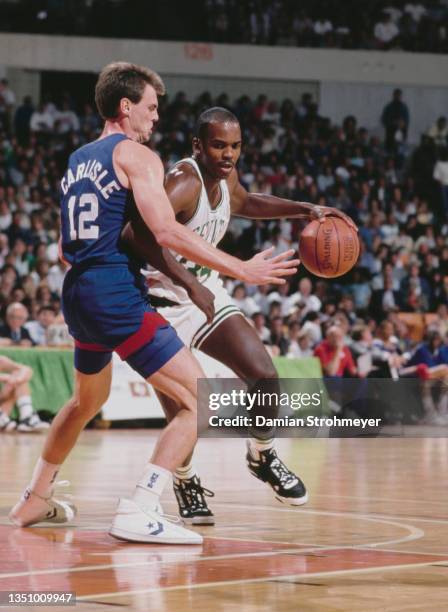 Kevin Gamble, Small Forward for the Boston Celtics dribbles the basketball around Rick Carlisle of the New Jersey Nets during their NBA Atlantic...