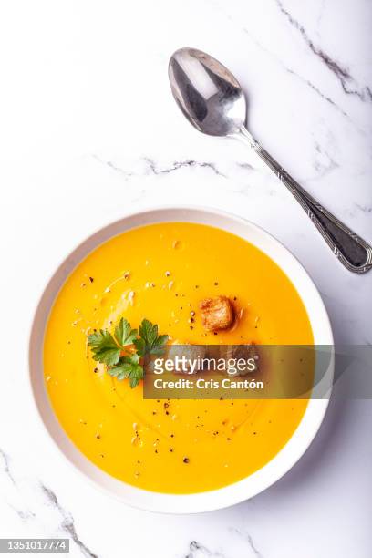pumpkin soup on white background - soup on spoon imagens e fotografias de stock