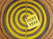 Concept of debt free with a sticky note on a target.