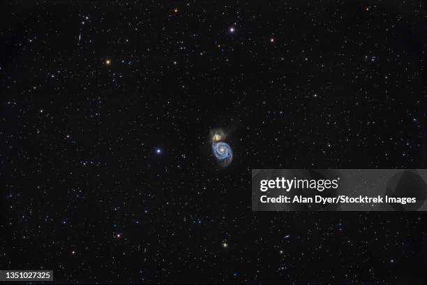 messier 51, the whirlpool galaxy in canes venatici. - m51 galaxy stock pictures, royalty-free photos & images