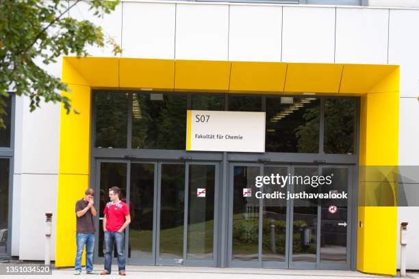 two male university students are standing in front of faculty for chemistry of university essen - entrance sign stock pictures, royalty-free photos & images