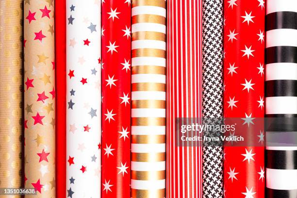 winter holidays multi colorful wrapping paper rolls. - envuelto fotografías e imágenes de stock