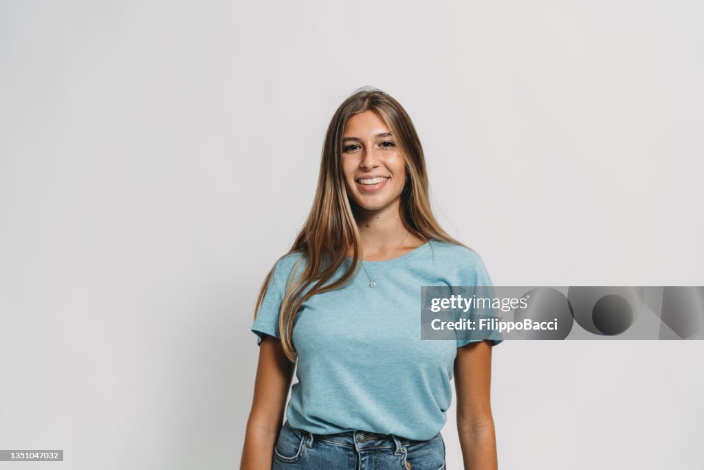 Portrait of a young adult woman against a white background