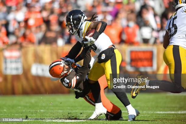 Sione Takitaki of the Cleveland Browns tackles Anthony McFarland of the Pittsburgh Steelers during the first half at FirstEnergy Stadium on October...