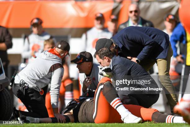 Jack Conklin of the Cleveland Browns is tended to by trainers after injuring his elbow during the first half against the Pittsburgh Steelers at...