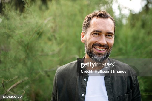 Portrait of happy mature man resting outdoors in park, looking at camera. Portrait of happy mature man resting outdoors in park, looking at camera.