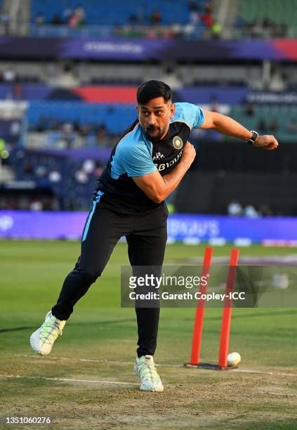 Dhoni, Mentor of India in bowling action ahead of the ICC Men's T20 World Cup match between India and Afghanistan at Sheikh Zayed stadium on November...