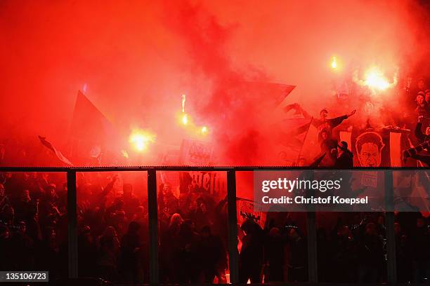 Fans of Leverkusen throw smokebombs during the UEFA Champions League group E match between KRC Genk and Bayer 04 Leverkusen at Cristal Arena on...