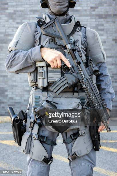 portrait of swat police officer holding firearm - military uniform stock pictures, royalty-free photos & images