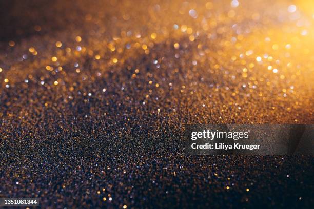 holiday glittering background - gold particle stock pictures, royalty-free photos & images