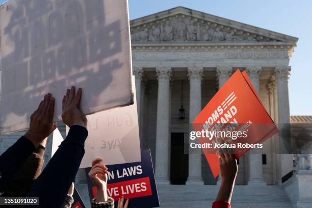 Supporters of gun control hold signs in front of supporters of gun rights during a demonstration by victims of gun violence in front of the Supreme...