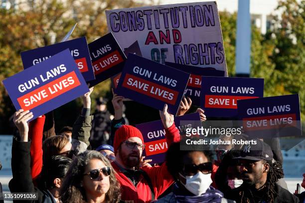 Supporters of gun control hold signs in front of supporters of gun rights during a demonstration by victims of gun violence in front of the Supreme...