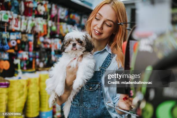 frau in der zoohandlung - pet equipment stock-fotos und bilder