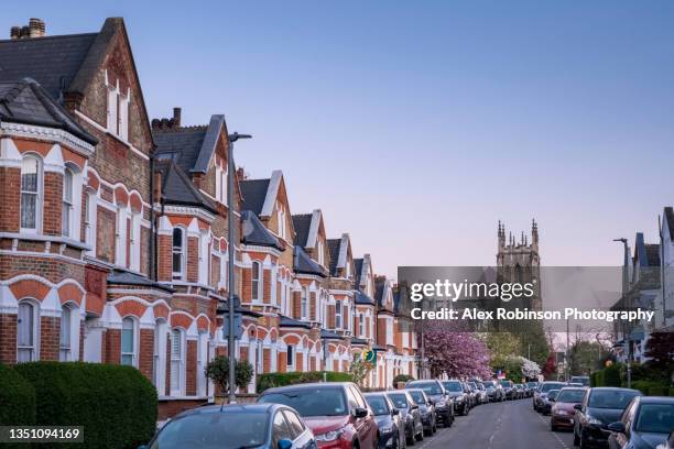 a residential street of victorian style terrace houses in london - home facade stock pictures, royalty-free photos & images