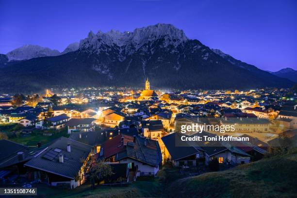 lightning streets of mittenwald during blue hour - mittenwald ストックフォトと画像