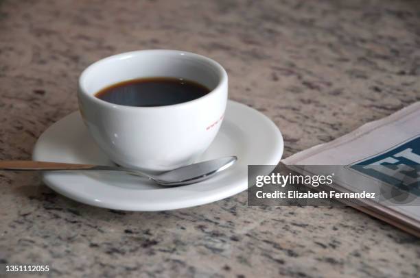 black coffee with newspaper on marble table - westers schrift stockfoto's en -beelden