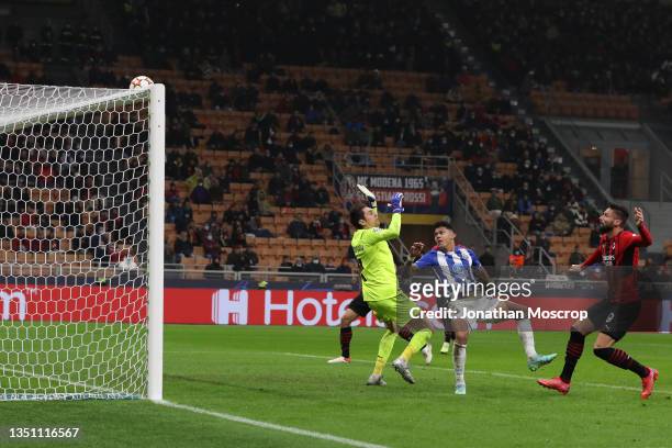 Evanilson of FC Porto looks on as his header rebounds off the crossbar after beating Ciprian Tatarusanu of AC Milan during the UEFA Champions League...