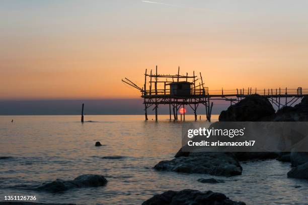 silhouette of a trabucco at sunset, pescara, abruzzo, italy - adriatic sea stock pictures, royalty-free photos & images