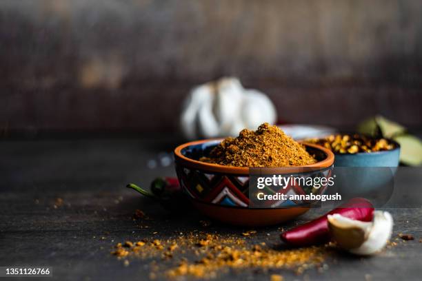 bowl of adjika spice with dried chilli, chilli peppers, salt, garlic and bay leaves on a table - food styling bildbanksfoton och bilder