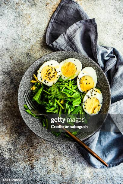 fresh sorrel leaf salad with boiled eggs and black sesame seeds - hard boiled eggs stock pictures, royalty-free photos & images