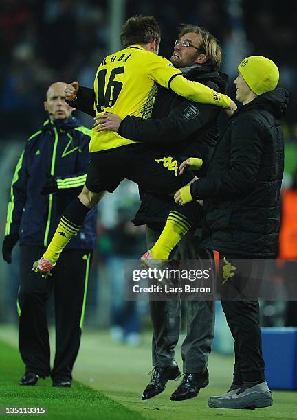 Jakub Blaszczykowski of Dortmund celebrates with head coach Juergen Klopp after scoring his teams first goal during the UEFA Champions League group F...