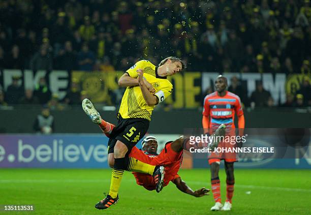 Dortmund's midfielder Sebastian Kehl is fouled by Marseille's cameroonian midfielder Stephane Mbia Etoundi during the UEFA Champions League group F...