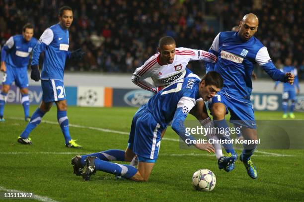 Jeroen Simaeys of Genk and Anthony Vanden Borre of Genk challenges Sidney Sam of Leverkusen during the UEFA Champions League group E match between...
