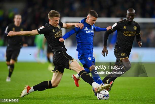 Kieron Evans of Cardiff City battles for the ball with Rob Dickie and Stefan Johansen of Queens Park Rangers during the Sky Bet Championship match...