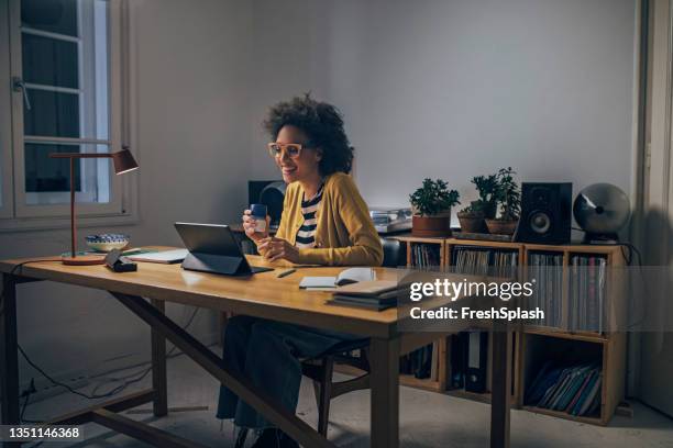 business woman using digital tablet at night - office space movie stock pictures, royalty-free photos & images