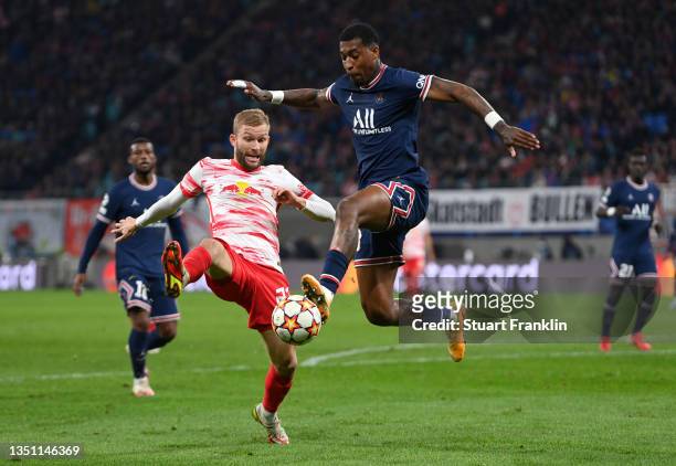 Presnel Kimpembe of Paris Saint-Germain battles for possession with Konrad Laimer of RB Leipzig during the UEFA Champions League group A match...