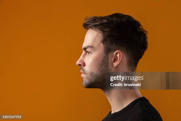 studio portrait of attractive 20 year old bearded man - in profile stock pictures, royalty-free photos & images