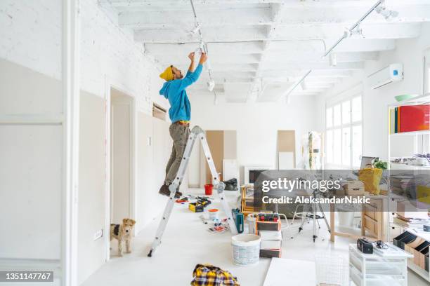 home renovation - installing ceiling light fixture stock pictures, royalty-free photos & images