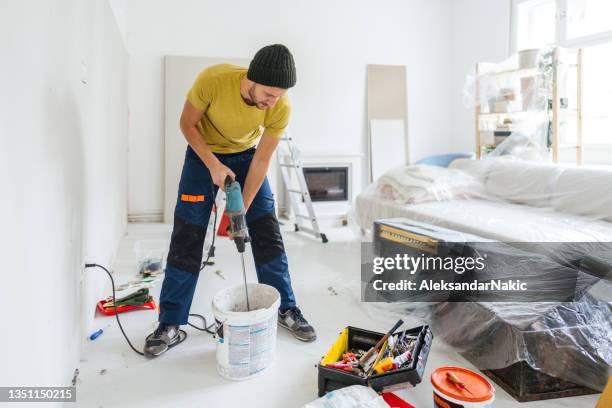 mixing the drywall mud - drywall finishing stock pictures, royalty-free photos & images