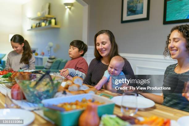 family praying before holiday dinner - indian family dinner table stock pictures, royalty-free photos & images