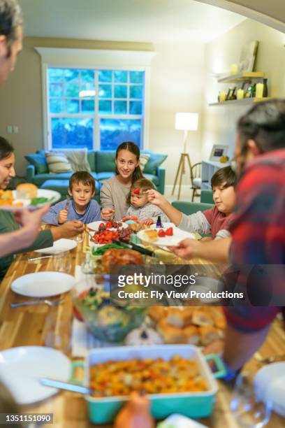 family eating together at holiday table - indian family dinner table stock pictures, royalty-free photos & images