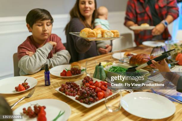 friends and family serving each other during holiday meal together - indian food bildbanksfoton och bilder